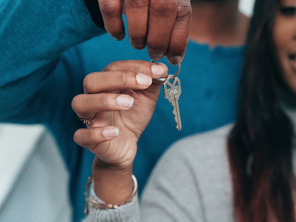 A couple holding the keys to a new home